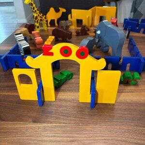 Colorful painted wooden zoo set toy, with animals, water feature, and iceberg